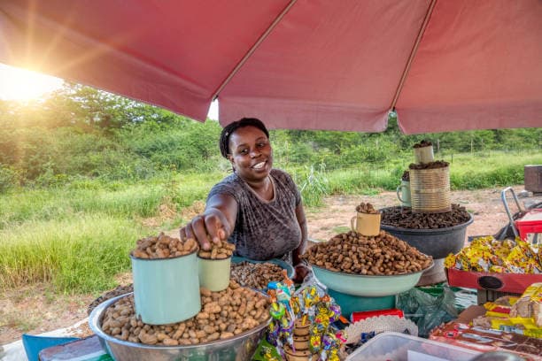 Woman entrepreneur standing beside her market stall